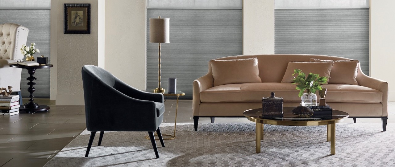 Living room with black and brown chair and sofa. Modern style with grey shades